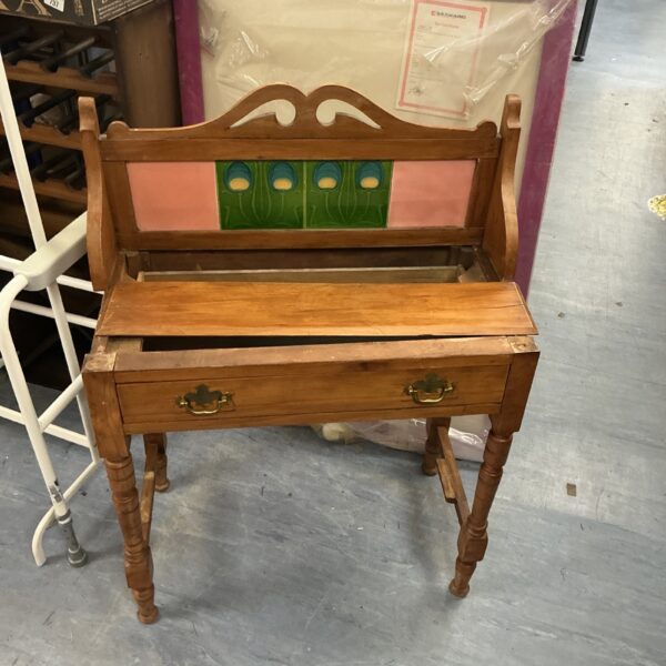 Side view of a vintage wooden washstand for restoration.