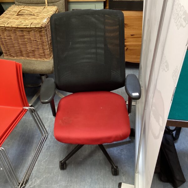 Front view of a red and black Vitra office chair.