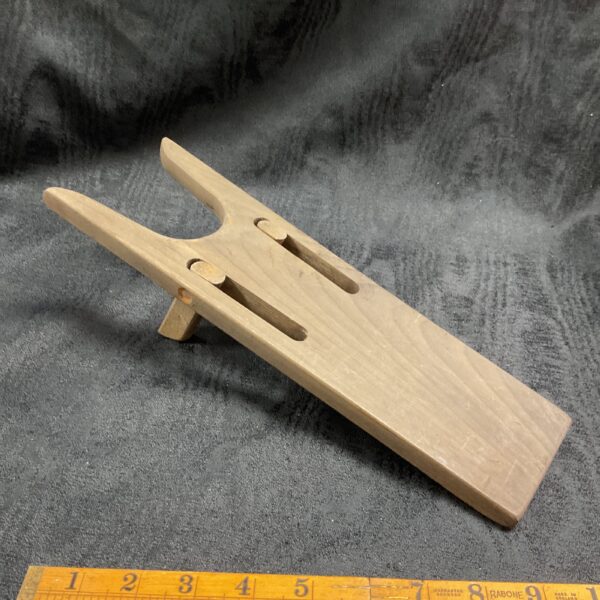 Vintage WWII German boot puller, wooden military footwear accessory.